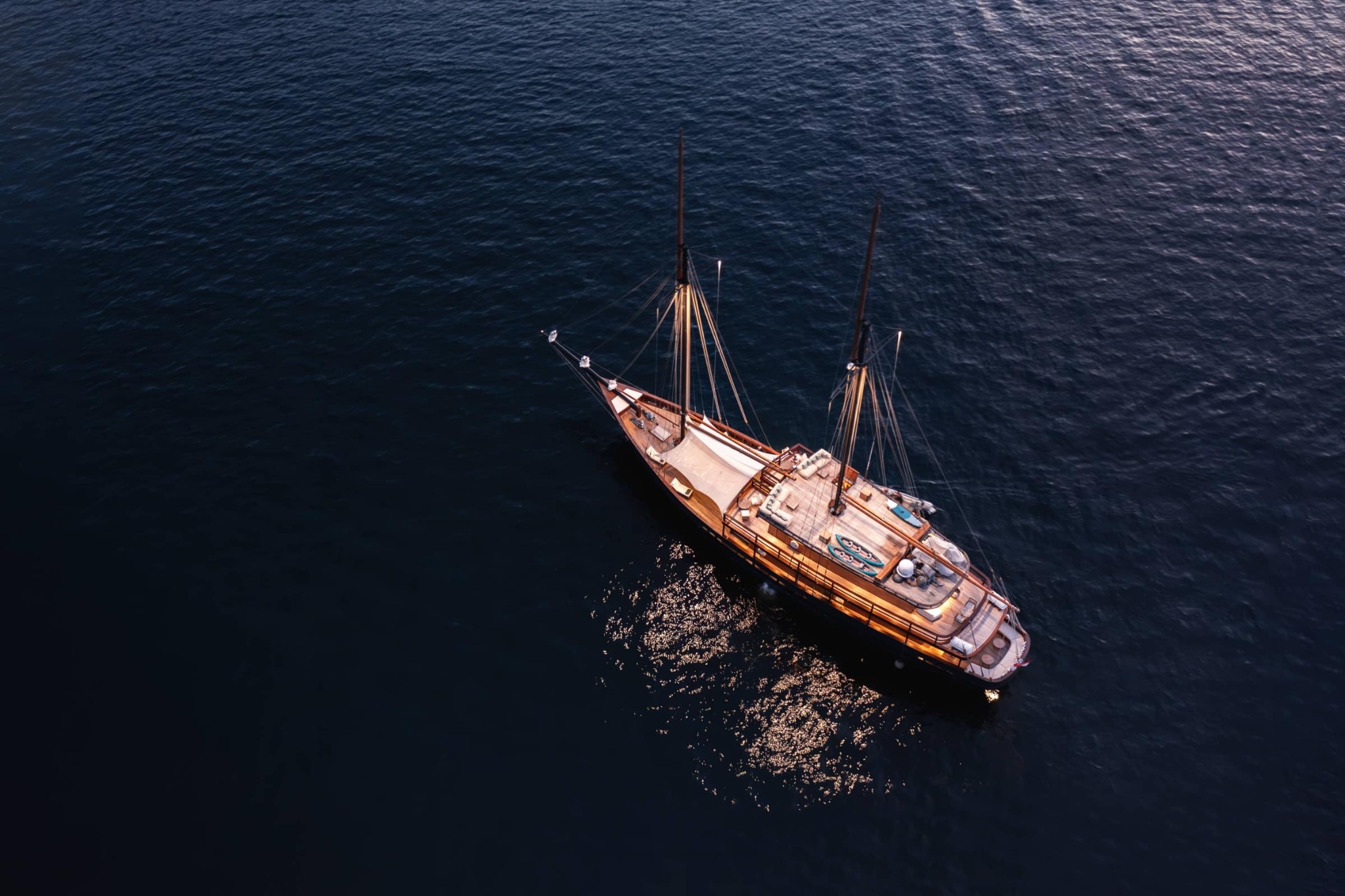 Vela Yacht sailing under full sail near Komodo