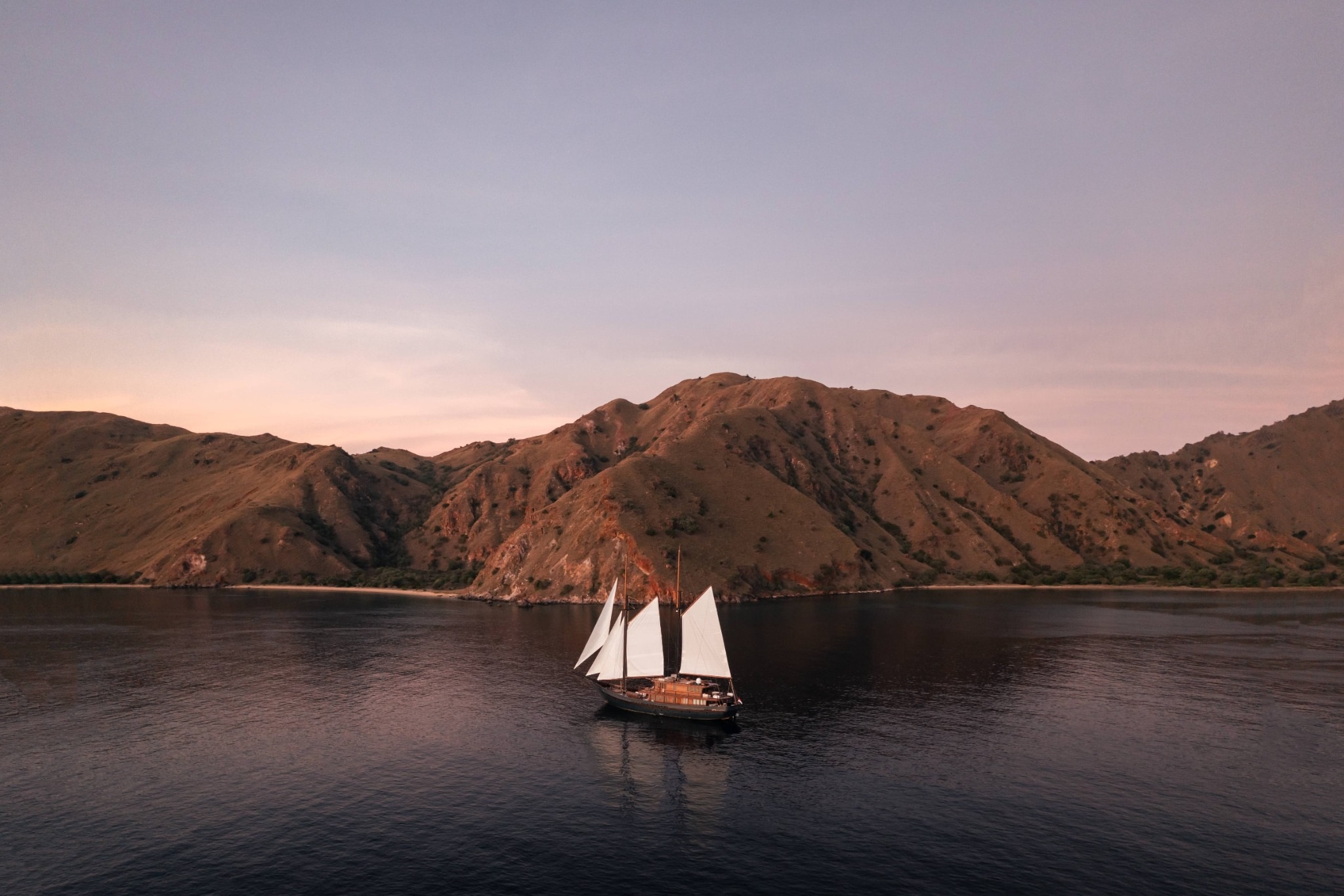 Vela Yacht sailing through the Indonesian archipelago