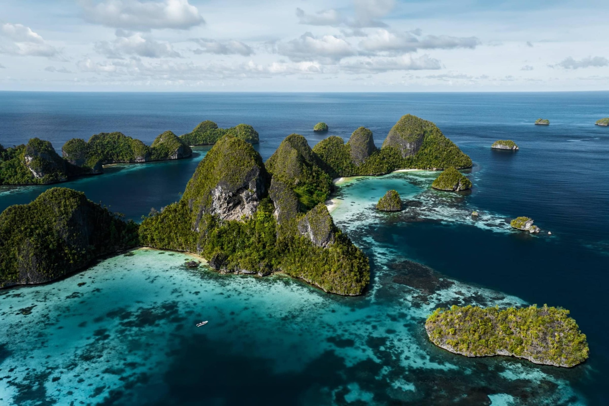 Clear Indonesian waters and tropical coastline explored on a Vela Yacht charter